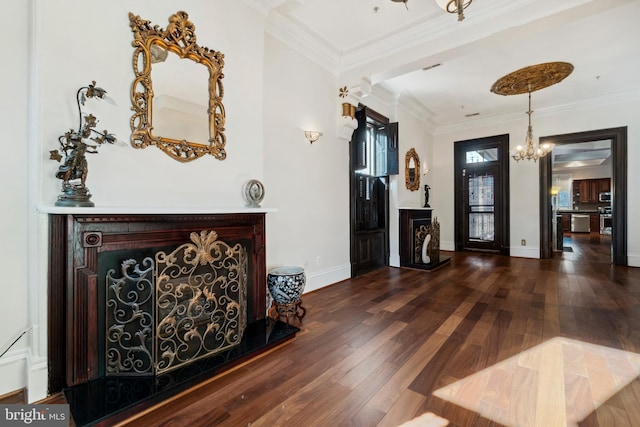 entryway with dark hardwood / wood-style flooring, crown molding, and a notable chandelier