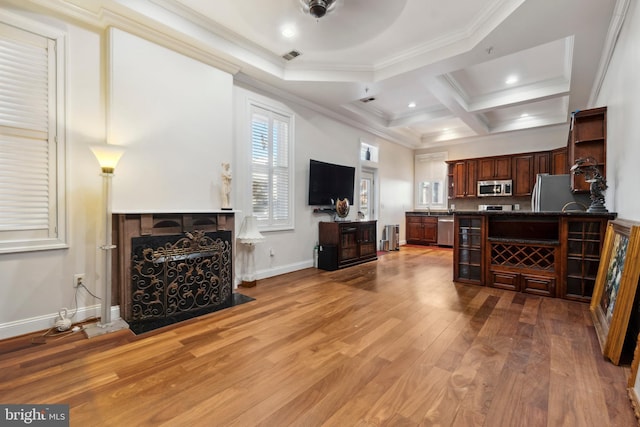 living room featuring ceiling fan, hardwood / wood-style floors, beamed ceiling, crown molding, and coffered ceiling