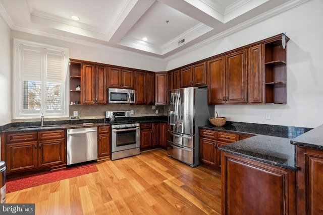 kitchen with light hardwood / wood-style floors, decorative backsplash, sink, stainless steel appliances, and dark stone counters