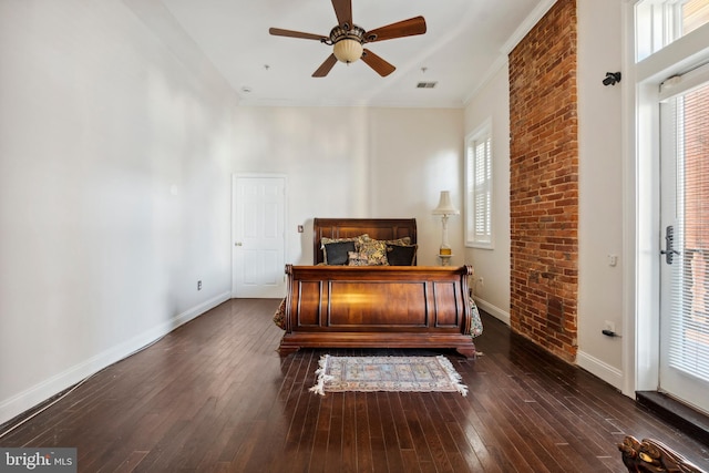 bedroom featuring ceiling fan, dark hardwood / wood-style flooring, and ornamental molding