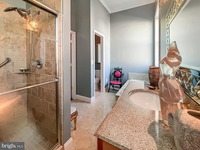 bathroom with toilet, vanity, ornamental molding, and an enclosed shower