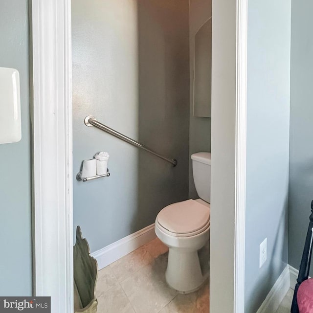 bathroom with toilet and tile patterned flooring