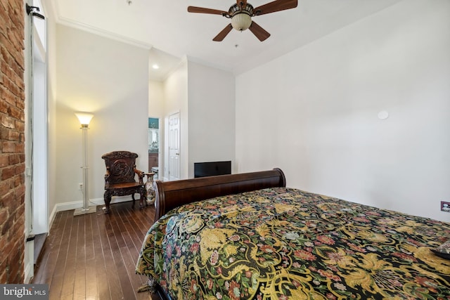 bedroom featuring ceiling fan, dark hardwood / wood-style flooring, and crown molding