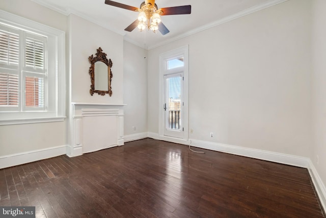 unfurnished room featuring dark wood-type flooring, plenty of natural light, and ornamental molding