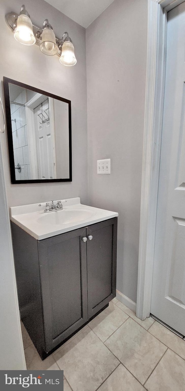 bathroom with tile patterned floors and vanity