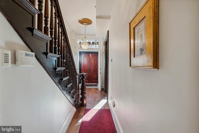 interior space featuring dark hardwood / wood-style floors and an inviting chandelier