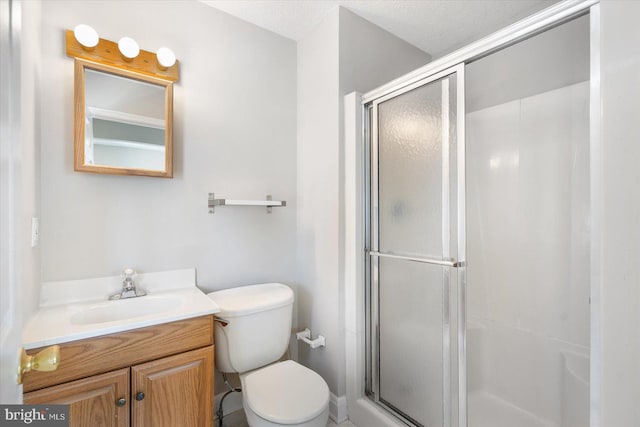 bathroom with toilet, a textured ceiling, walk in shower, and vanity