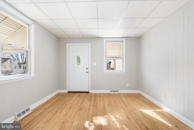 entryway featuring light hardwood / wood-style floors and a drop ceiling