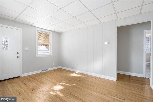 foyer with a drop ceiling and light hardwood / wood-style floors