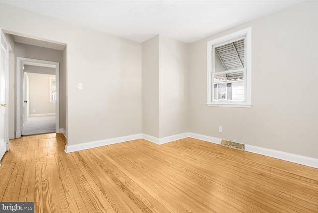 unfurnished room with light wood-type flooring