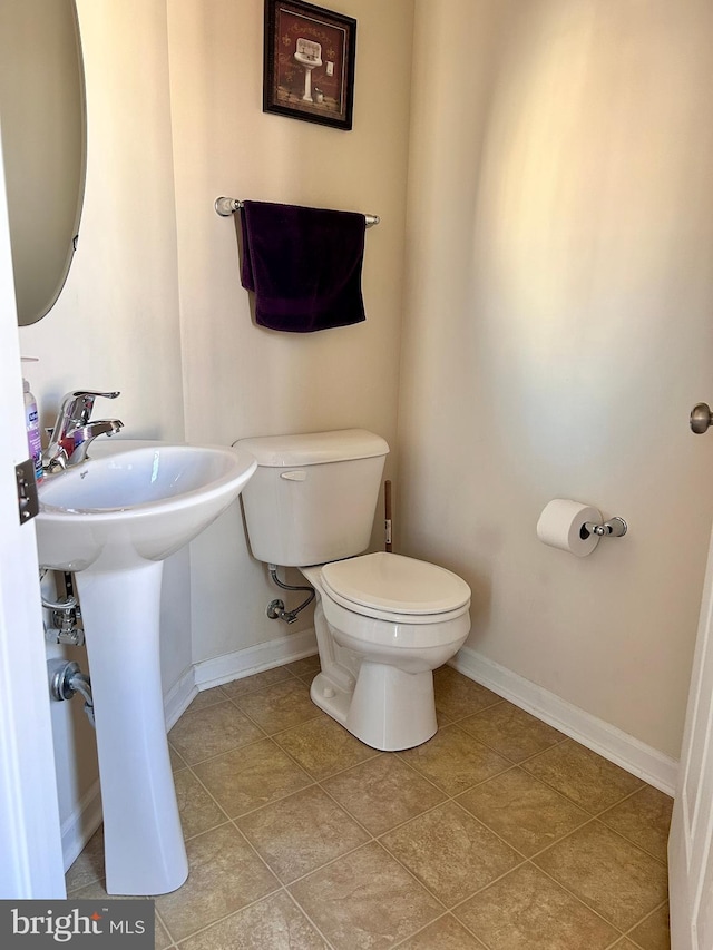 bathroom featuring toilet and tile patterned flooring