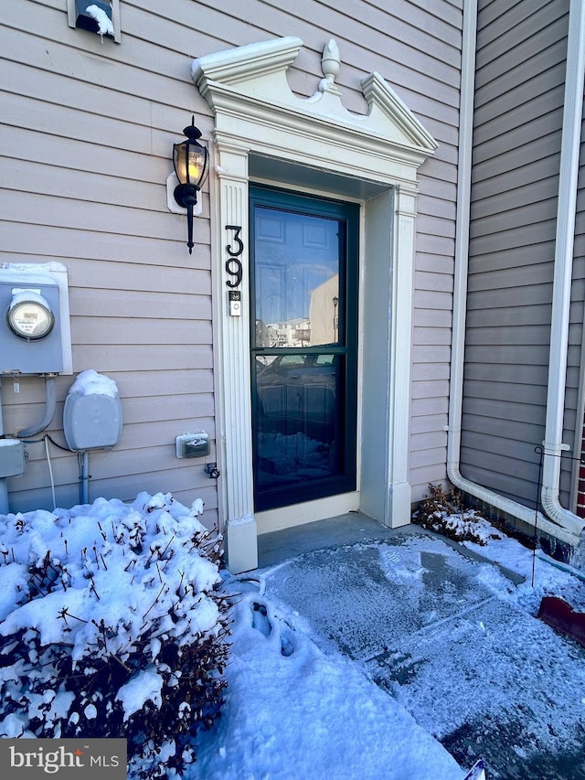 view of snow covered property entrance