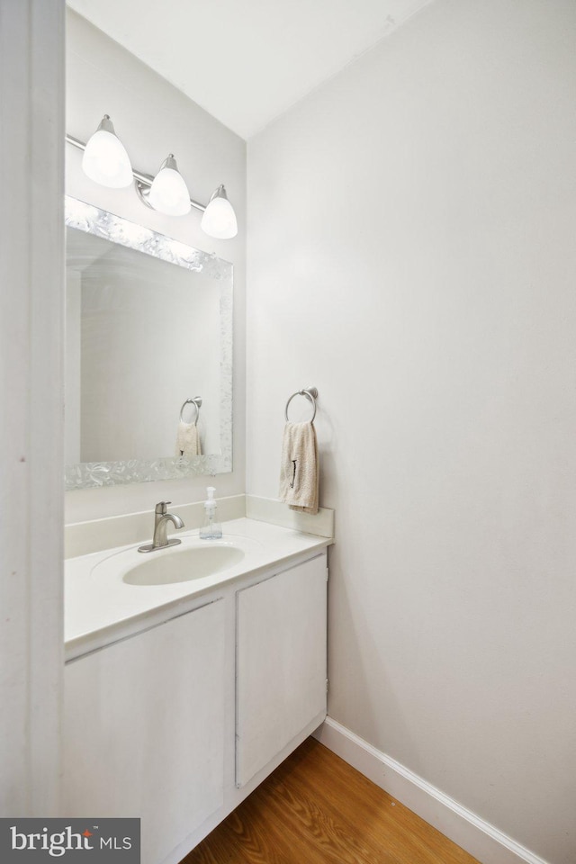 bathroom featuring hardwood / wood-style flooring and vanity