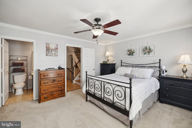 bedroom featuring ensuite bath, ceiling fan, and crown molding