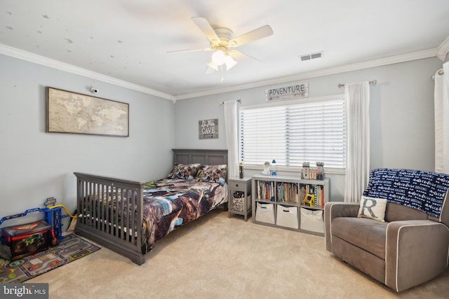 carpeted bedroom with ceiling fan and ornamental molding