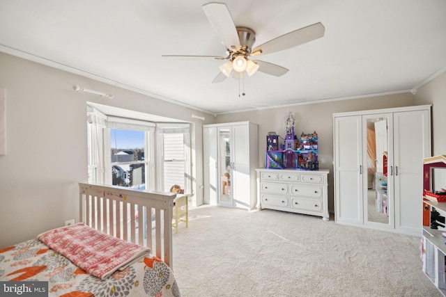 bedroom with ceiling fan, light carpet, and crown molding