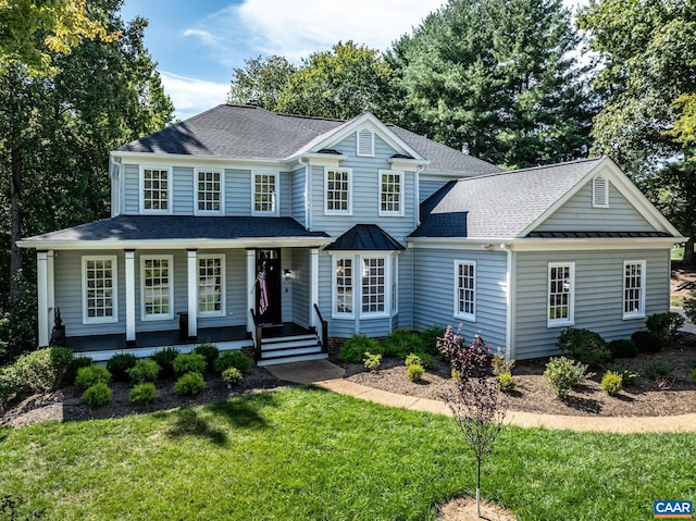 view of front of property with covered porch and a front lawn