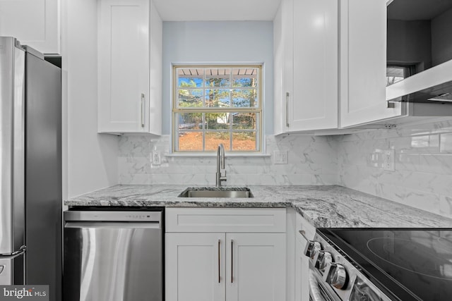 kitchen with extractor fan, white cabinets, sink, and stainless steel appliances