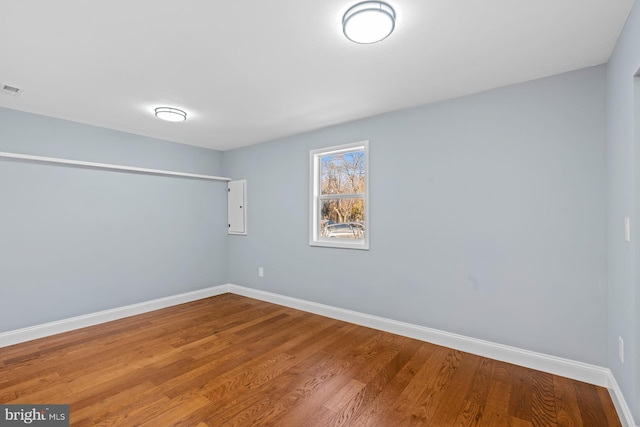 spare room featuring wood-type flooring