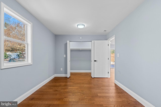 unfurnished bedroom featuring a closet and wood-type flooring