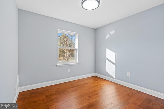 spare room featuring wood-type flooring