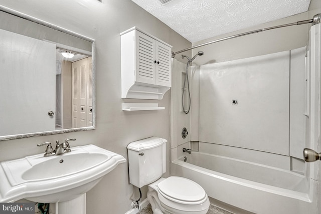 full bathroom featuring sink, toilet, a textured ceiling, and shower / bathing tub combination