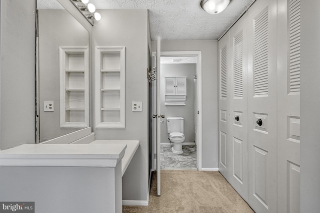 bathroom with a textured ceiling and toilet