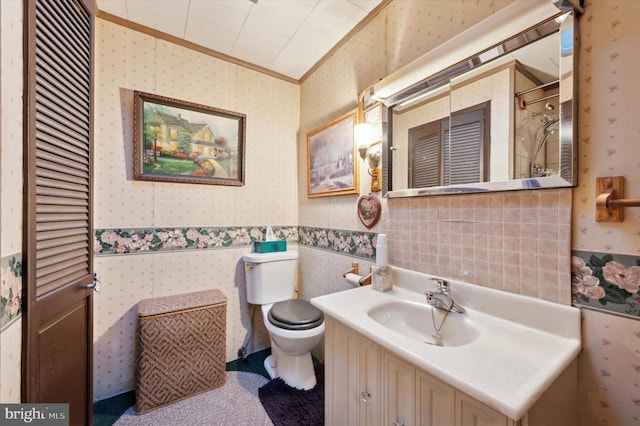 bathroom featuring toilet, ornamental molding, walk in shower, and vanity