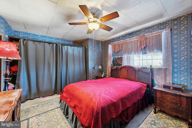 bedroom featuring ceiling fan and a drop ceiling