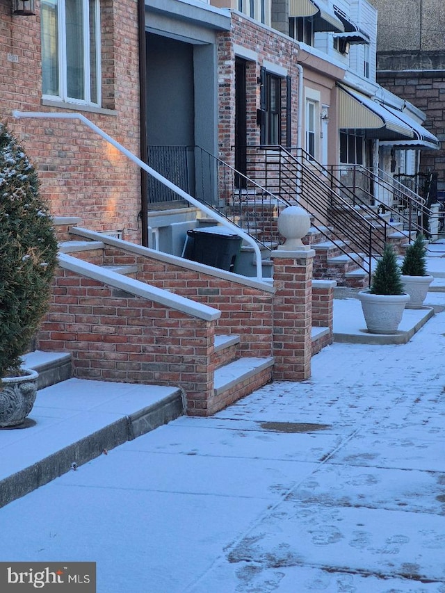 view of snow covered property entrance