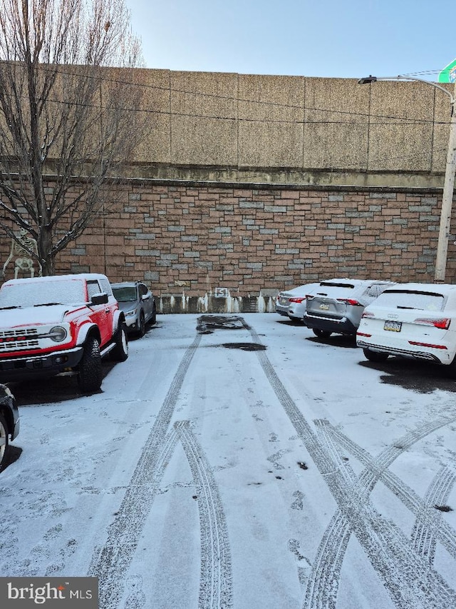 view of snow covered parking