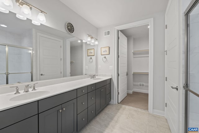 bathroom featuring an enclosed shower and vanity