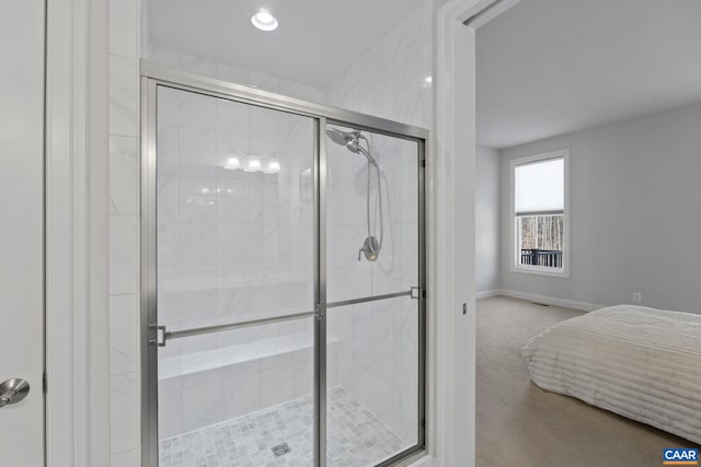 bathroom featuring a shower with shower door