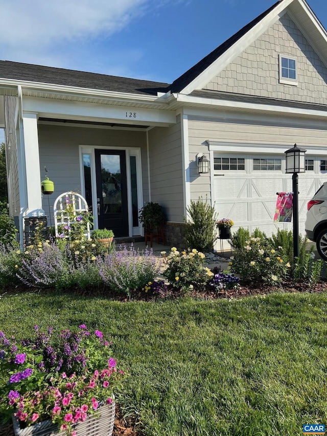 view of front facade with a front lawn and a garage