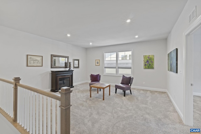 living area with light colored carpet