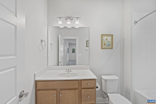 full bathroom with toilet, vanity, and tiled shower / bath