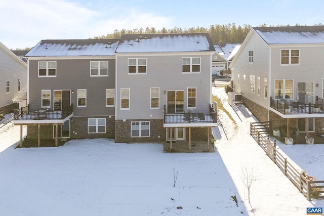 view of snow covered rear of property