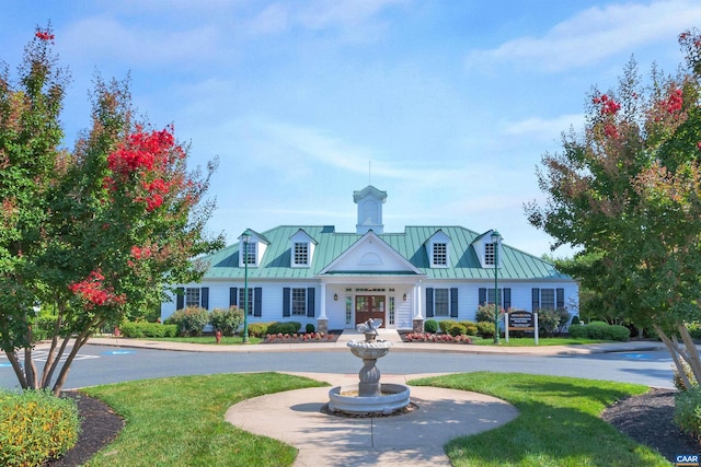 new england style home with a front yard