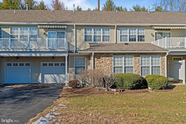 view of property with a front lawn and a garage