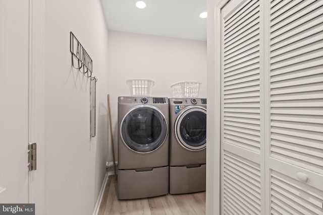 washroom featuring washer and dryer and light hardwood / wood-style floors