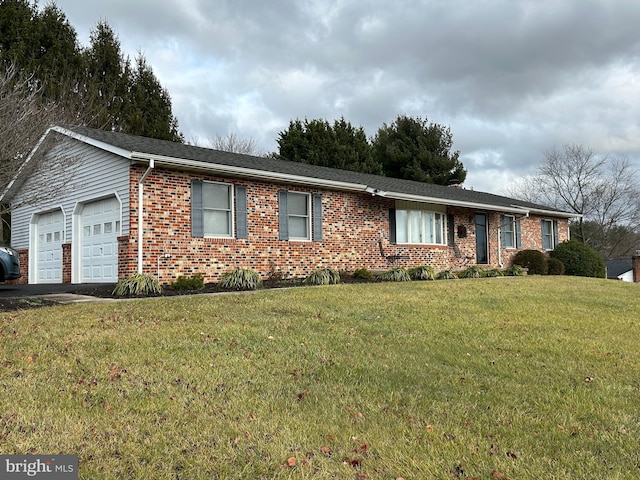 ranch-style house featuring a garage and a front lawn