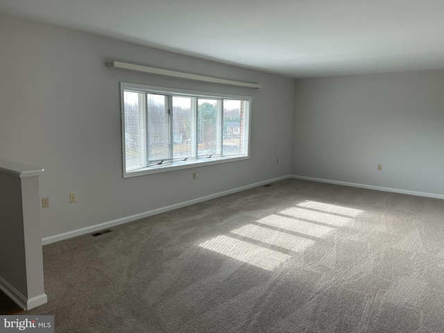 empty room featuring dark colored carpet