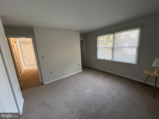 unfurnished room with light carpet