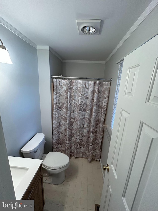 bathroom featuring toilet, vanity, and crown molding