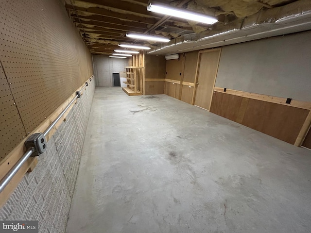 basement featuring wood walls