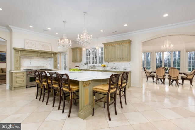 kitchen with hanging light fixtures, light tile patterned floors, a large island, and high end stove