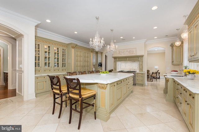 kitchen with decorative light fixtures, a breakfast bar, light tile patterned floors, and a kitchen island