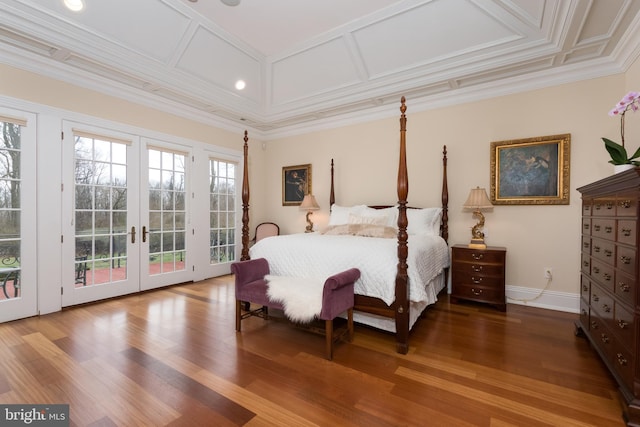 bedroom with hardwood / wood-style floors, coffered ceiling, access to exterior, french doors, and ornamental molding