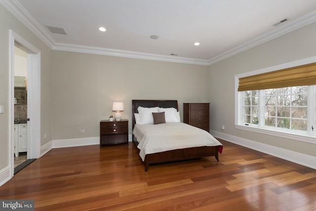 bedroom with crown molding, connected bathroom, and hardwood / wood-style floors