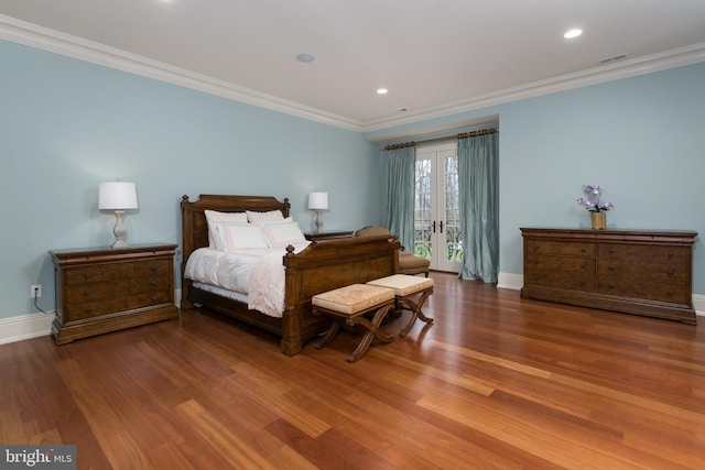 bedroom with wood-type flooring, ornamental molding, and french doors